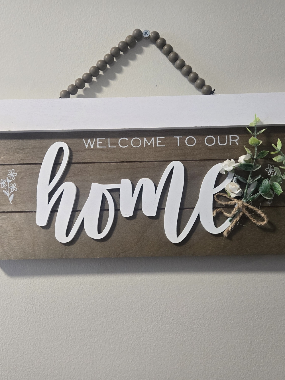 Welcome to Our Home Wooden Wall Sign - White Script on Brown